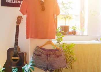 Warm and inviting living space featuring casual wear, guitar, and indoor plants.