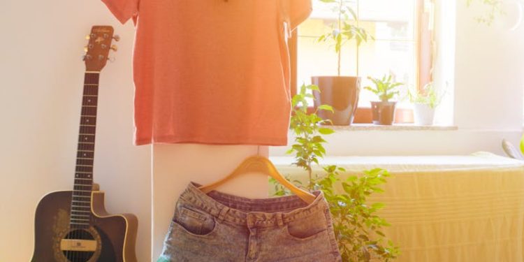 Warm and inviting living space featuring casual wear, guitar, and indoor plants.