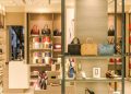 Chic boutique with a variety of handbags and shoes elegantly displayed on shelves.