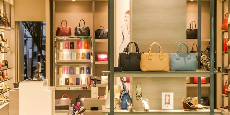 Chic boutique with a variety of handbags and shoes elegantly displayed on shelves.