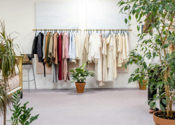 Chic fashion boutique showcasing vibrant clothing collection with lush indoor plants.