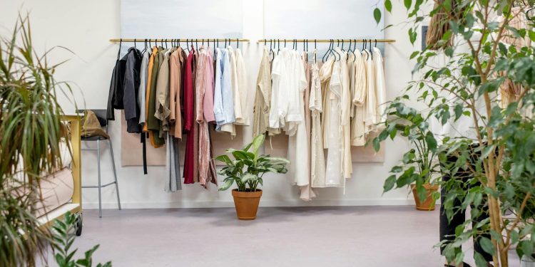 Chic fashion boutique showcasing vibrant clothing collection with lush indoor plants.