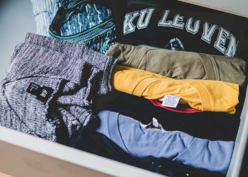 A neat arrangement of clothes and T-shirts in a drawer, showcasing casual wear.